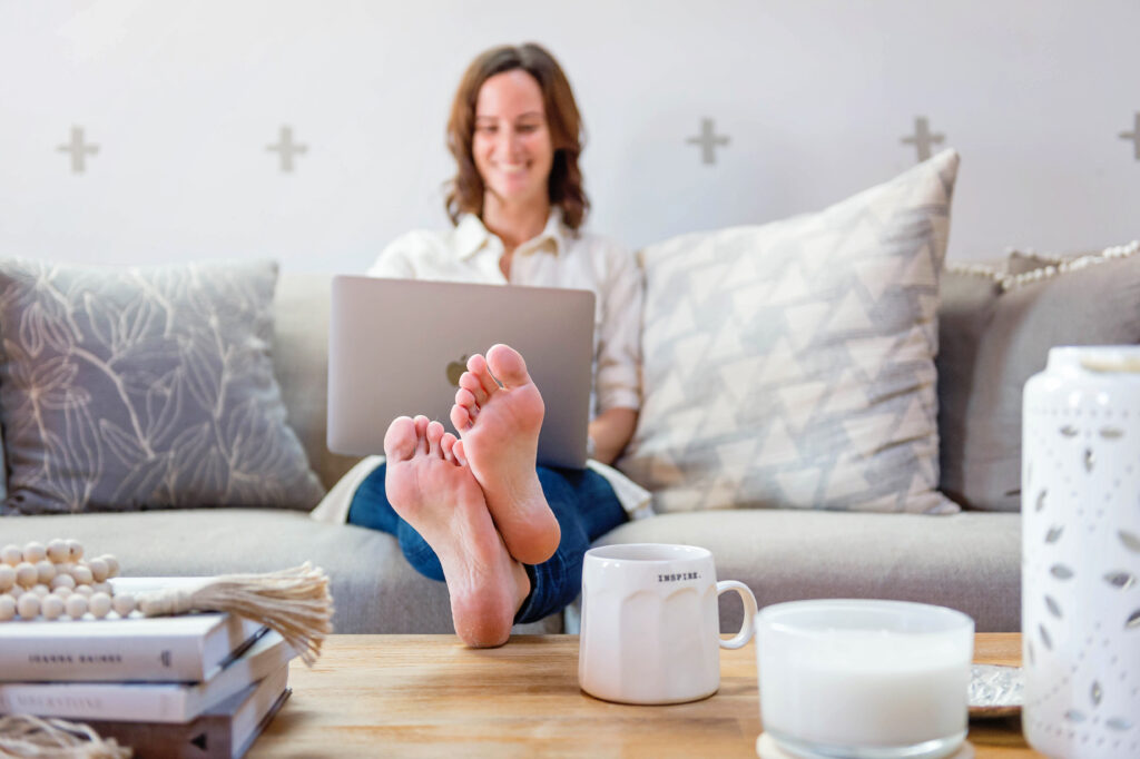 Happy businesswoman on couch.