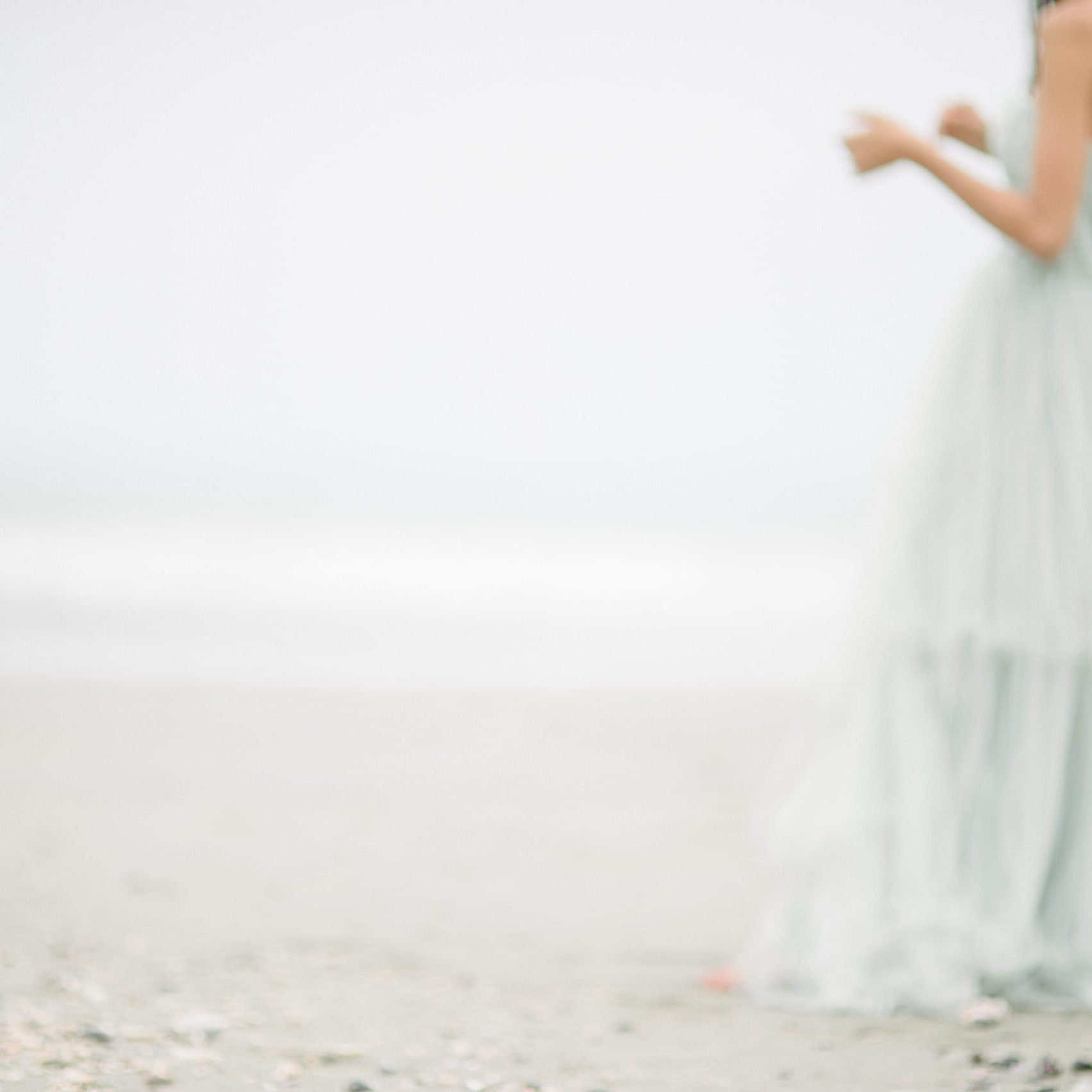 blurry woman in a pastel ble dress